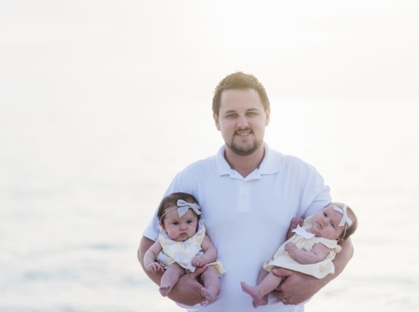 Happy father holding babies (2-5 months)