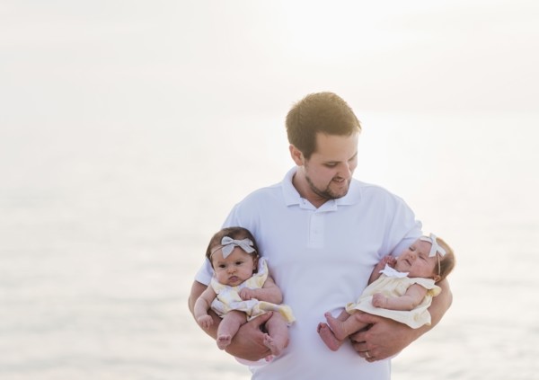 Happy father holding babies (2-5 months)