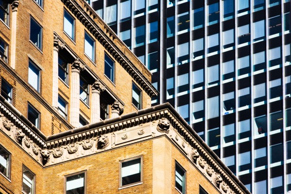 USA, New York, Old building and modern office block behind
