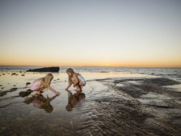 Girls (6-7,8-9) playing on beach