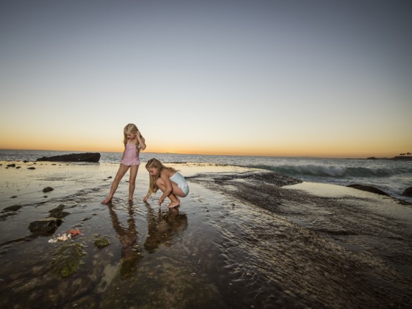 Girls (6-7,8-9) playing on beach