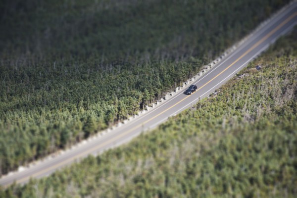 USA, New York, Wilmington, Car driving on road through forest