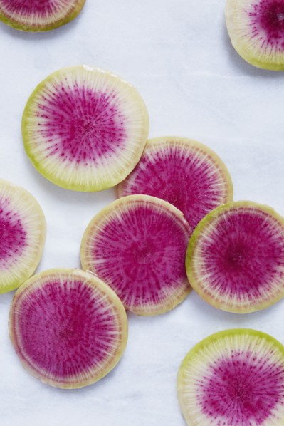 Slices of radish on white surface