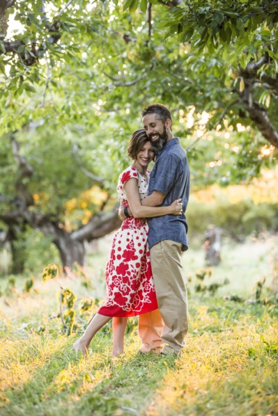 Couple embracing in cherry orchard