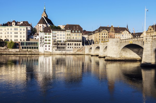 Switzerland, Basel, Basel-Stadt, Houses by Rhine River and stone bridge