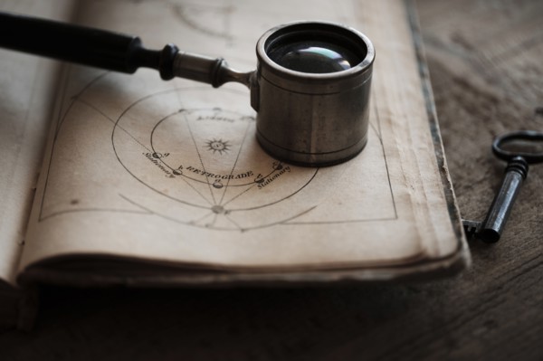Antique magnifying glass and book.