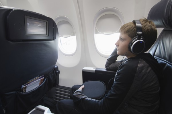 Boy watching tv in aero plane