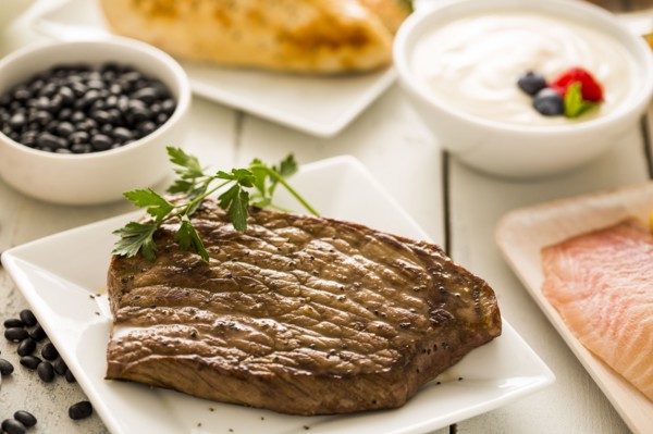 Grilled chicken served with black beans, yogurt and cottage cheese