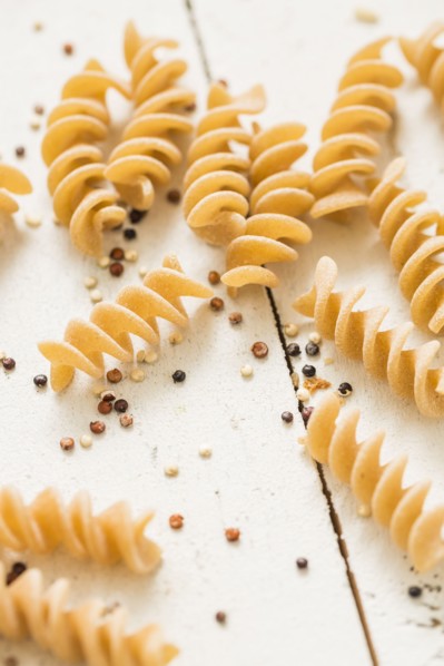 Pasta and quinoa on white background