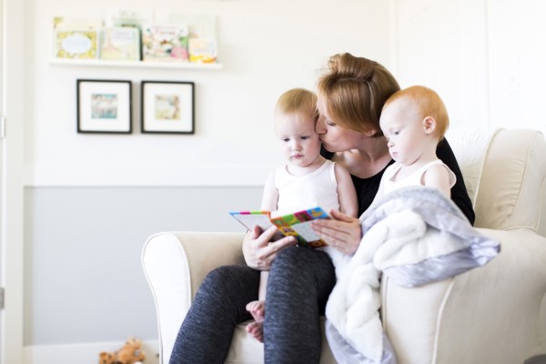 Mother and sons (12-17 months) reading picture book