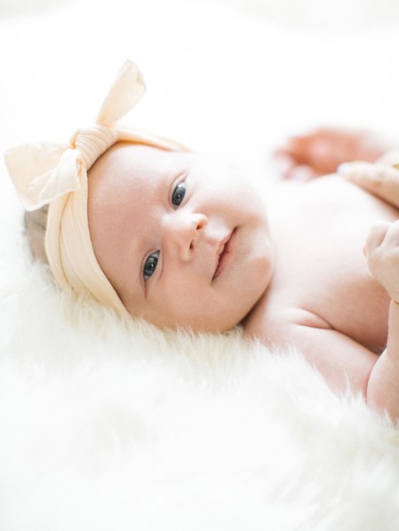 Portrait of girl (0-1 months) with ribbon on head