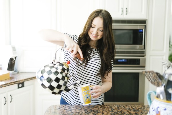 Woman pouring water from teapot