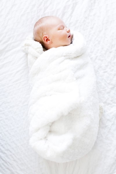 Baby boy (2-5 months) sleeping in white blanket