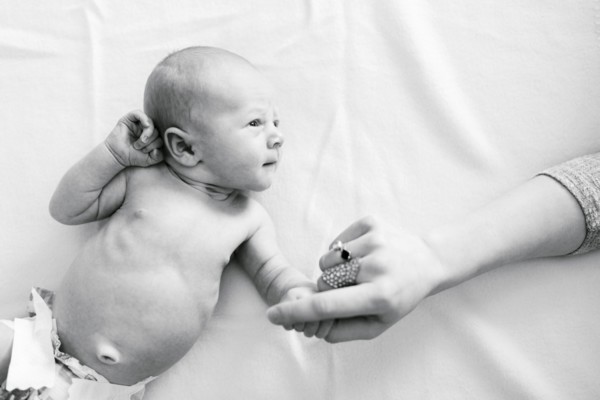 Portrait of newborn boy ( 0-1 months ) holding mother's hand