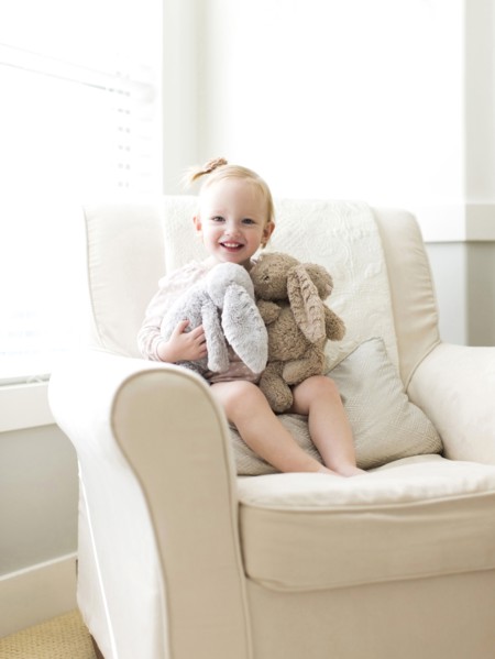 Portrait of girl ( 12-17 months ) holding stuffed toys