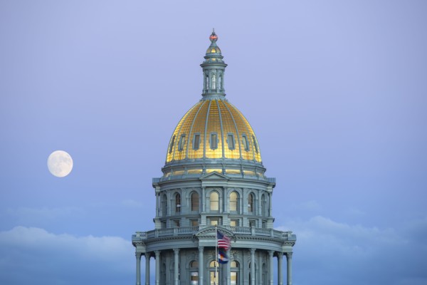 USA, Colorado, Denver, Full moon rising next to State Capitol dome
