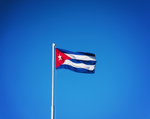 Cuba, Havana, Cuban flag with blue sky