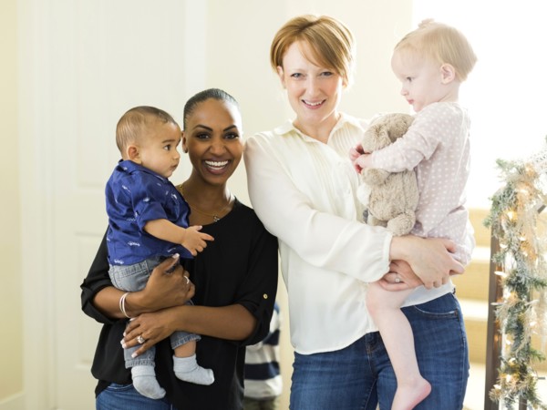 Portrait of mothers holding children (2-5 months, 12-17months)