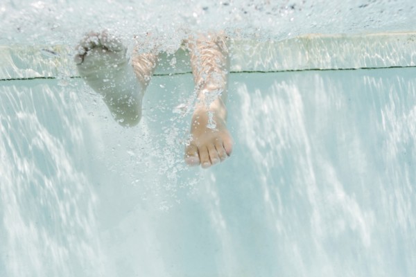 Legs of girl (4-5) underwater