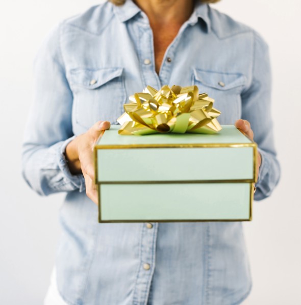 Mid section of Mature woman holding gift