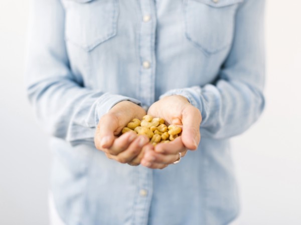 Woman holding handful of nuts