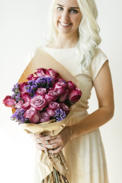 Woman holding bouquet with roses
