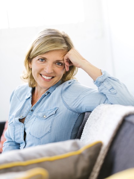 Portrait of woman sitting on sofa