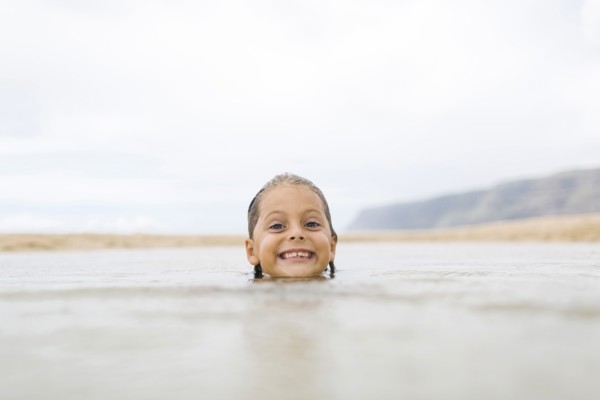 Girl (6-7) swimming in sea