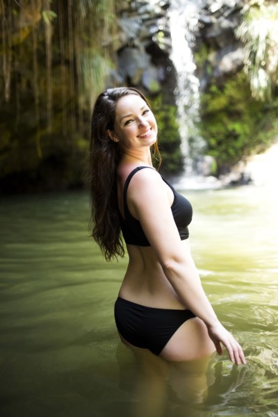 Caribbean Islands, Saint Lucia, Woman standing in water by waterfall