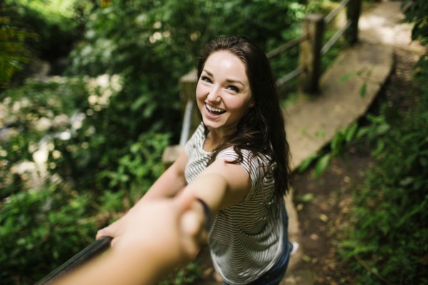 Caribbean Islands, Saint Lucia, Smiling women standing on path, holding person's hand and looking at camera