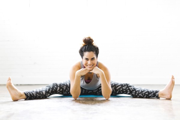 Portrait of woman stretching on exercise mat
