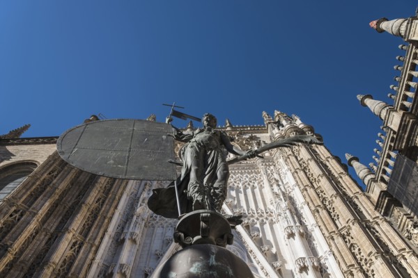 Spain, Seville, Facade of Cathedral of Seville with statue