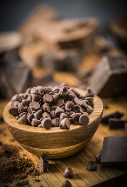 Bowl of chocolate chips on cutting board