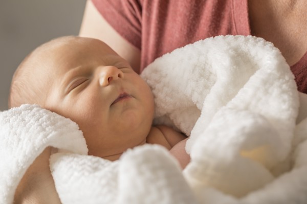 Baby boy (0-1 months) in mothers arms