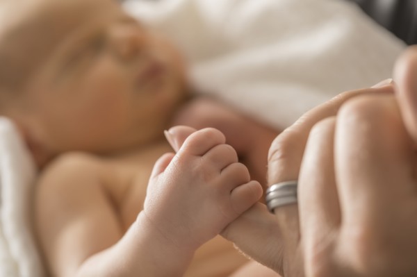 Newborn son (0-1 month) holding father's finger