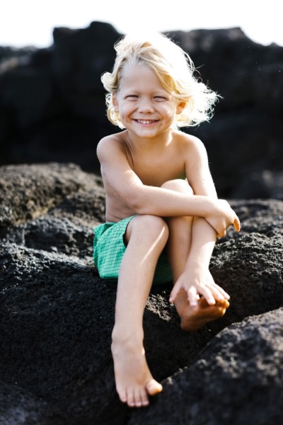 Boy (4-5) playing on rocks