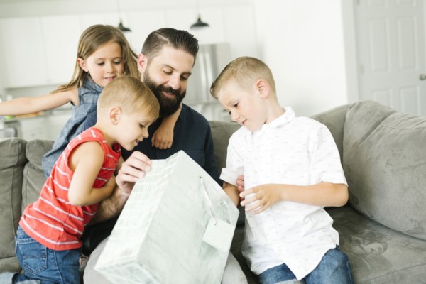 Family with three children (2-3, 6-7) celebrating fathers day