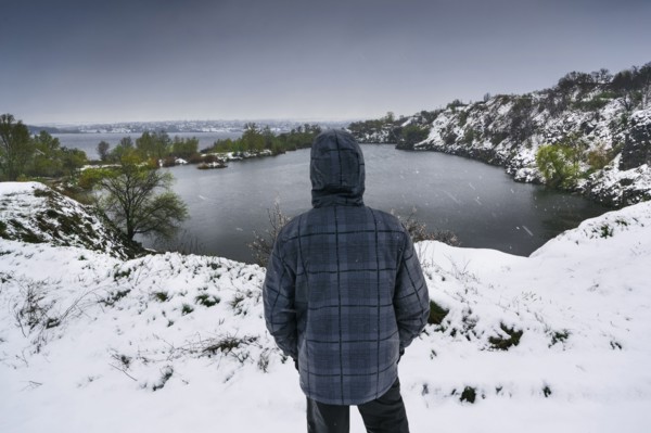 Ukraine, Dnepropetrovsk region, Dnepropetrovsk city, Person looking over winter landscape with lakes