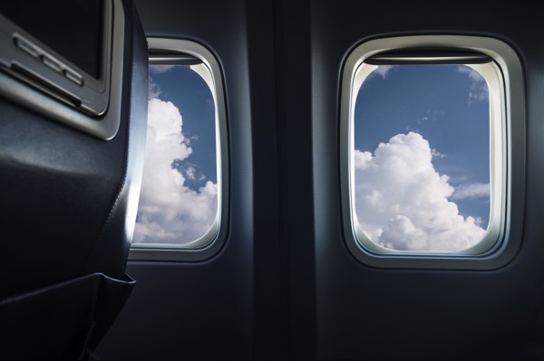 Clouds behind airplane window
