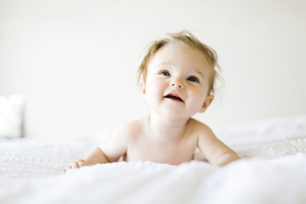 Baby girl (6-11 months) playing in bedroom