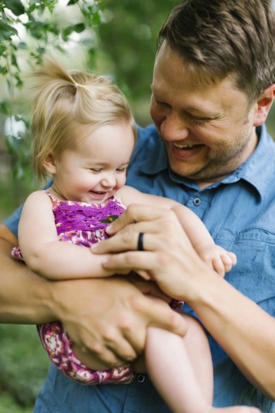 Father playing with baby girl (12-17 months) in backyard