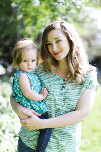 Portrait of mother and baby girl (12-17 months) in backyard