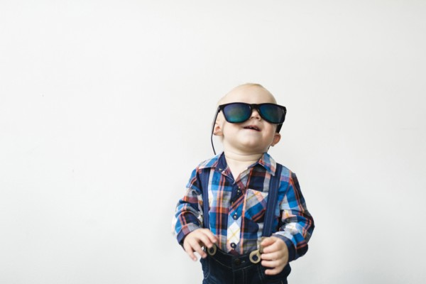 Studio shot of baby boy (12-17 months) wearing sunglasses