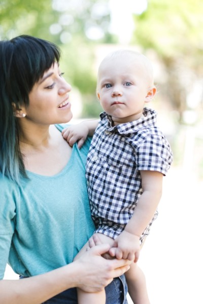 Mother carrying baby boy (12-17 months)