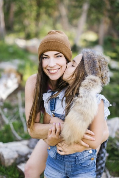 Portrait of mother with daughter (8-9) hiking in forest