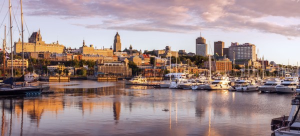 Canada, Quebec, Quebec City, Coastline with marina and buildings reflected in water