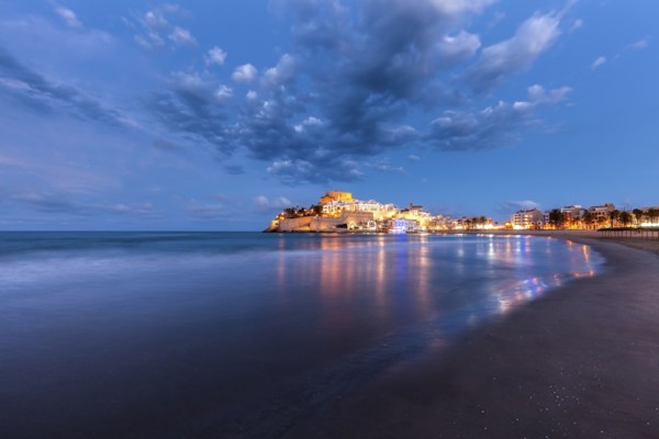 Spain, Valencian Community, Peniscola, Illuminated town by sea