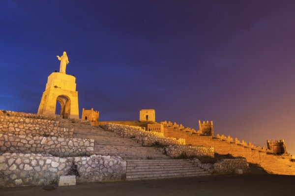 Spain, Andalusia, Almeria, Statue of Sacred Heart of Jesus at dusk