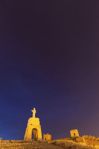 Spain, Andalusia, Almeria, Statue of Sacred Heart of Jesus at dusk