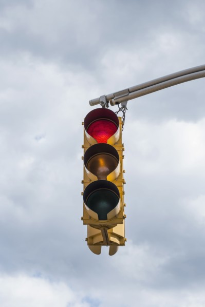 Traffic light against storm clouds